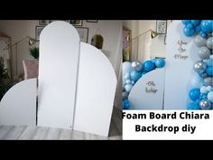 a room decorated with balloons and surfboards on the wall, along with an advertisement for foam board chair back drop diy