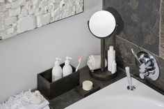 a bathroom sink with soap, toothbrushes and other personal care items on it