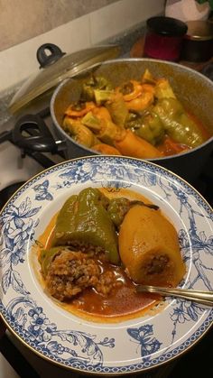 two plates filled with food on top of a stove