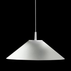 a white light hanging from the ceiling in front of a black background with no one around it