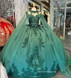 a dress on display in a store window with other dresses and accessories behind it,