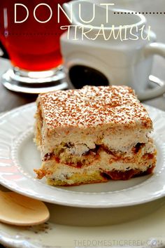 a plate with a sandwich on it next to a cup of tea