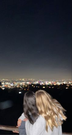 two girls looking out at the city lights