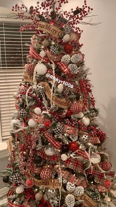 a christmas tree decorated with red, white and black ornaments