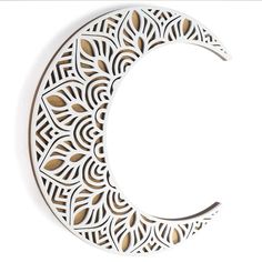 a paper cut out of the shape of a crescent with leaves on it's side