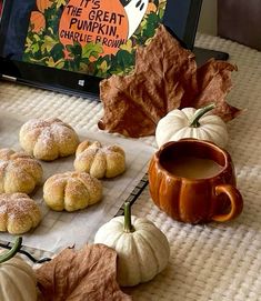 pumpkins and other fall foods on a table with a tablet computer in the background