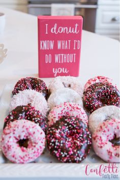 donuts with sprinkles are sitting on a plate next to a sign that says i donut know what to do without you