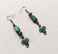 These stylish asymmetrical Elephant Earrings feature detailed patinaed metal charms and gorgeous Czech glass beads. They come with silicone nuts for extra security. Elephant Jewelry, Elephant Earrings, Metal Charms, Bead Pattern, Bean Recipes, Metal Charm, Czech Beads, Bead Designs, Czech Glass Beads