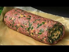 a meatloaf roll with spinach and cheese on it