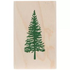 a rubber stamp with a green pine tree on it's front and back side