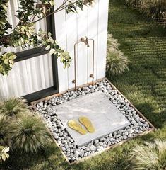 a pair of yellow flip flops sitting on top of a stepping stone in the grass