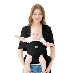 a woman is holding a baby in her arms and smiling at the camera while standing against a white background