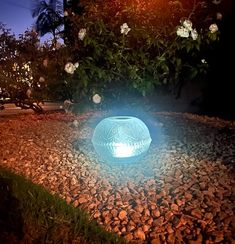 a light that is on some rocks in the grass