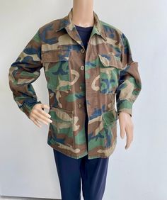 "VTG 1980's Army Surplus USMC Camo Jacket. Excellent condition- no rips or tears. Heavyweight cotton. Four front button flap pockets, button wrist cuffs, button front. Below hip length. Label: Propper. Size XS. Measurements Flat: Shoulder top seam to seam:16-1/2\"W, Chest 20\", Sleeve inseam 20\", Length from back collar 28\"L, Hip width at hem 20\"W." Camouflage Cotton Outerwear With Flap Pockets, Military Camouflage Outerwear With Buttons, Camouflage Cotton Outerwear With Pockets, Cotton Camouflage Outerwear With Pockets, Army Surplus, Camouflage Jacket, Camo Jacket, Wrist Cuffs, Hip Length