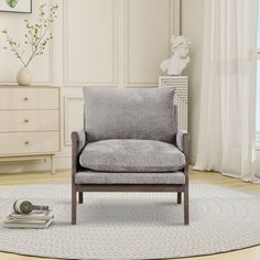 a gray chair sitting on top of a white rug