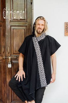 "Organic Cotton Black Hooded Shirt for Men. This new beautiful artefact from our Organic collection is also very cozy and comfortable to wear. Shirt tunic is an original Chintamani Alchemistry design that combines knee length ethnic tunic with short sleeved button shirt. This model looks like a mantle that is worn on top of a shirt, but spares you the unnecessary layers, and does not slide off your shoulders. It has a soft pilgrim hood for extra comfort and deep side pockets. The front panels ar Black Cotton Outerwear For Festivals, Black Cotton Festival Outerwear, Black Bohemian Hoodie, Bohemian Black Hooded Hoodie, Hooded Cotton Top For Festivals, Tunic Men, White Boho Skirt, Organic Clothing Women, Button Shirts Men