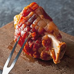 a piece of meat on a cutting board with a fork