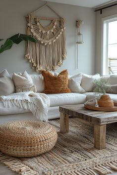 a living room filled with lots of white furniture and pillows on top of a rug