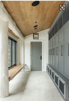 a long hallway with several lockers and a bench