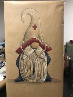 a drawing of a gnome with a red cross on it's hat and nose