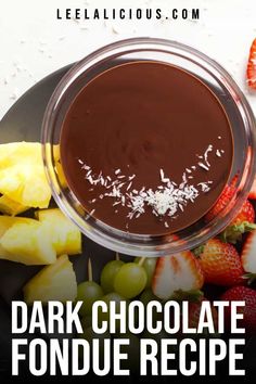 chocolate fondue recipe on a plate with strawberries and fruit in the background text reads dark chocolate fondue recipe