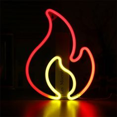 a red and yellow light shines in the dark, creating a glowing flame effect