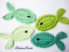 three crocheted fish sitting next to each other