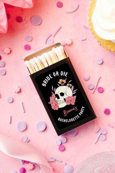 a box of matches sitting on top of a pink table