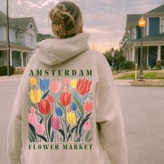 Get cozy in style with our Flower Market Hoodie! Made from soft, durable material, it features a vibrant print inspired by the bustling Amsterdam tulip flower market. Perfect for adding a pop of color to your wardrobe and showing off your love for flowers and travel. Order now and bloom with confidence! ♥ We want you to be happy with your item, and for it to bring you joy! If you have any problems with your order or your item, please contact us prior to leaving a review. We will do what we can t Amsterdam Flower Market, Amsterdam Tulips, Flower Hoodie, Tulip Flower, Happy Customer, Tulips Flowers, Flower Market, To Be Happy, Getting Cozy