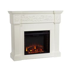 a white fireplace with a fire in it