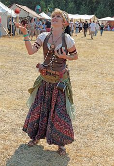 a woman is standing in the middle of a field