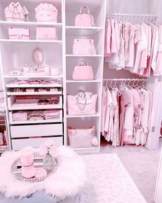 a room filled with lots of pink and white furniture next to a closet full of baby's clothes