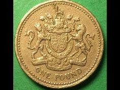 an old british one pound coin on a green tablecloth with the word'one pound'printed on it