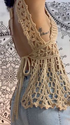 the back of a woman's top with crochet