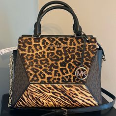 Crafted With Blend Of Animal-Print Calf Hair, Leather And Logo Print, The Prism Satchel Will Lend Geometric Edge To The Season’s Luxe Looks. The Compact Design Unzips To Reveal An Interior That’s Roomy Enough To Store Everyday Essentials. Wear It As A Crossbody Bag Or Carry It By The Top Handles. Top-Handle Bag Printed Calf Hair/Leather/Logo-Print Canvas 100% Leather Trim 1: 100% Calf Hair Gold Tone Hardware 12"W X 10"H X 5"D Handle Drop: 4.25" Exterior Details: Front Snap Pocket Interior Detail Leopard Print Bag With Gold-tone Hardware And Top Handle, Leopard Print Bags With Gold-tone Hardware For Shopping, Leopard Print Top Handle Bag With Gold-tone Hardware, Leopard Print Leather Bag With Gold-tone Hardware, Leopard Print Handbags, Exterior Details, Michael Kors Purse, Leather Logo, Purses Michael Kors