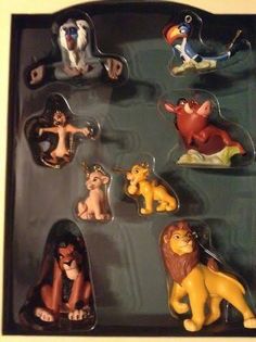 the lion king figurines are on display in a black plastic box with white trim