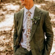 a man wearing a suit and tie with flowers on his lapel