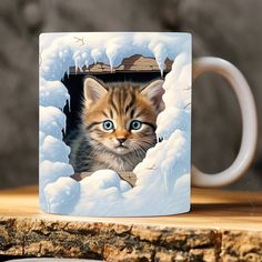 a coffee mug with a kitten peeking out of it's hole