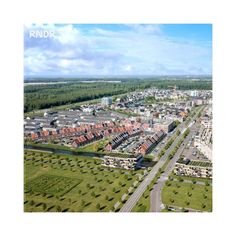 an aerial view of a large city with lots of buildings and green grass in the foreground