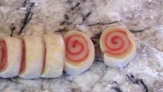 some kind of food that is on top of a marble countertop and has been cut in half to look like spirals