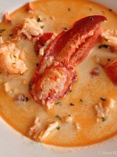 there is a lobster soup in the bowl