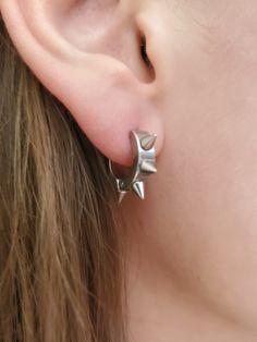 Spike hoop earrings, Spiked ear hoops, Punk Emo Rock Rebel earrings, Gothic spike earrings, Stainless steel dainty spike hoops TO SEE ALL ITEMS IN OUR SHOP, CLICK HERE: https://www.etsy.com/shop/thefandomempress ** 9mm hoops ** Unisex ** Sold in pairs - 2 earrings  ** Hypo-Allergenic ** Stainless Steel ** 6 spikes all around hoop ** Light and comfortable Show of your style, whether it is punk, rock, emo, goth, rebel or just to add a little flare to your look! GUARANTEE If you are not satisfied in any way, message us first and we will make it right. PROCESSING We work hard to prepare and ship all orders within 1 - 3 business days after receiving it. SHIPPING  - CANADA: 3 - 10 business days - USA: 5 - 15 business days ♥BUY WITH CONFIDENCE♥ Please know that customer service is very important Tripple Helix Ear Piercings Spikes, Spiked Hoop Earrings, Emo Earrings Aesthetic, Masc Earrings, Spikes Aesthetic, Spiked Earrings, Emo Earrings, Punk Piercings, Alternative Earrings