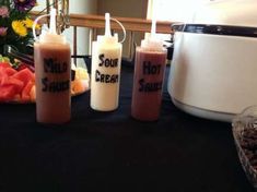 three drinks sitting on top of a table next to an orange juicer and blender