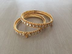 *This is Gold Finish Kundan Bangles pair.Its Perfect for Wedding Occasion as well as Unique and Ethnic Traditional Bangle to gift and Also Bridal wear to match with Wedding Outfits. *Its made from Silver n Copper mix material and 100% Handmade. *Its available in Various Sizes like 2,2.2,2.4,2.6 Etc Its white kundan combination like shown in picture. *Its open able Screwed Bangles Pair. *All Kundan stones set with silver foils handsetting method and long last guarantee of its workmanship.It is Wh Diwali Reception Bangle Bracelets, Stone Work Bracelets For Diwali Reception, Stone Work Bracelets For Reception And Diwali, Traditional Meenakari Bracelets For Reception, Temple Jewelry Bangle For Festivals And Receptions, Temple Jewelry Bangle For Receptions And Festivals, Temple Jewelry Bangle For Reception And Festivals, Traditional Stone Work Bangle For Reception, Traditional Festive Bracelets For Reception