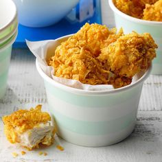 two cups filled with food sitting on top of a table