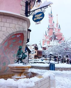 the entrance to disneyland's sleeping beauty castle is covered in snow