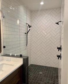 a bathroom with a walk in shower next to a sink