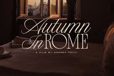 an advertisement for autumn in rome, with the sun coming out from a window and on top of a bed