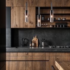 a kitchen with wooden cabinets and black counter tops, including a cutting board on the sink