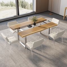 a dining table with four chairs and a potted plant on it in an empty room